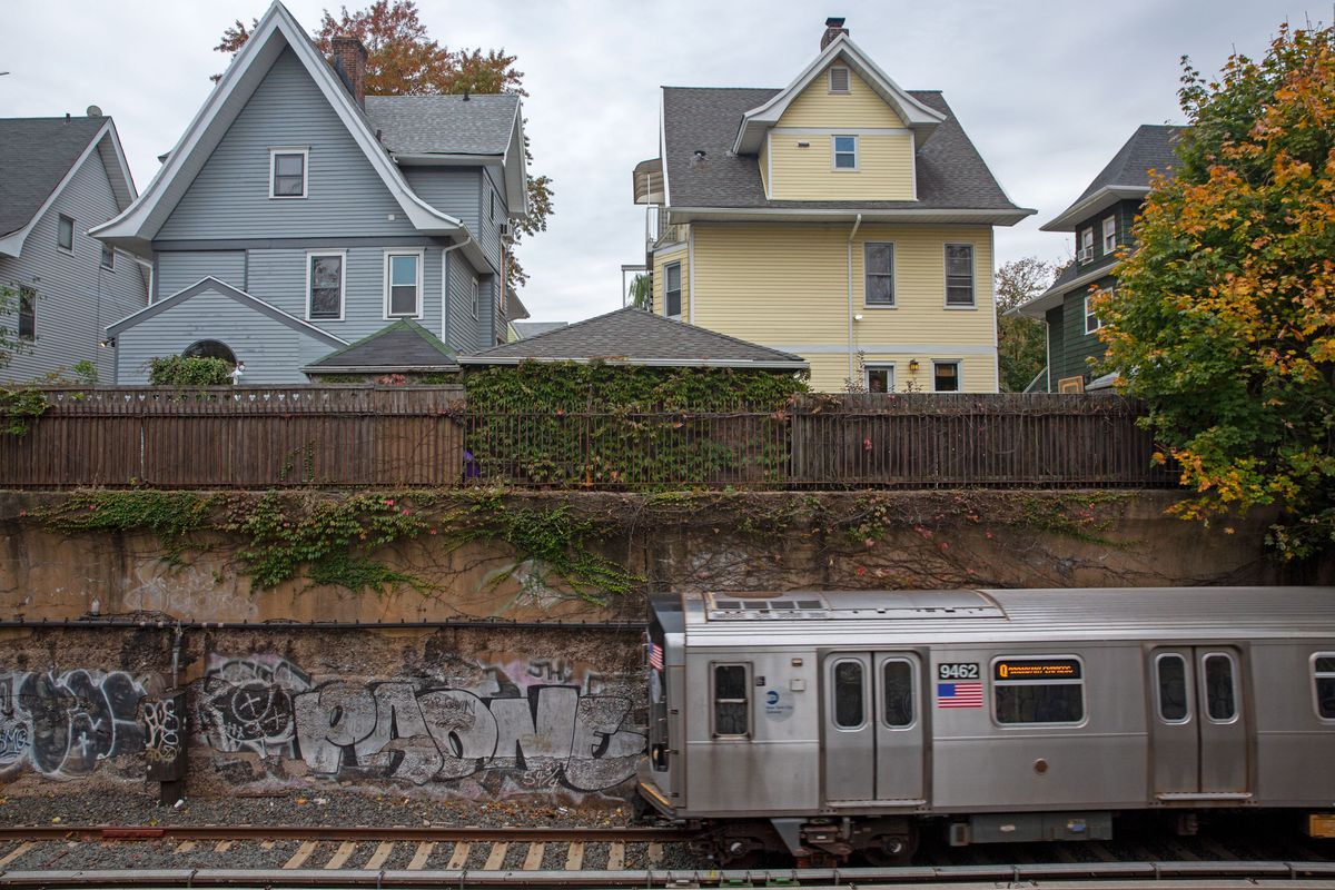 a barrier and fence save the sight and noise of a train